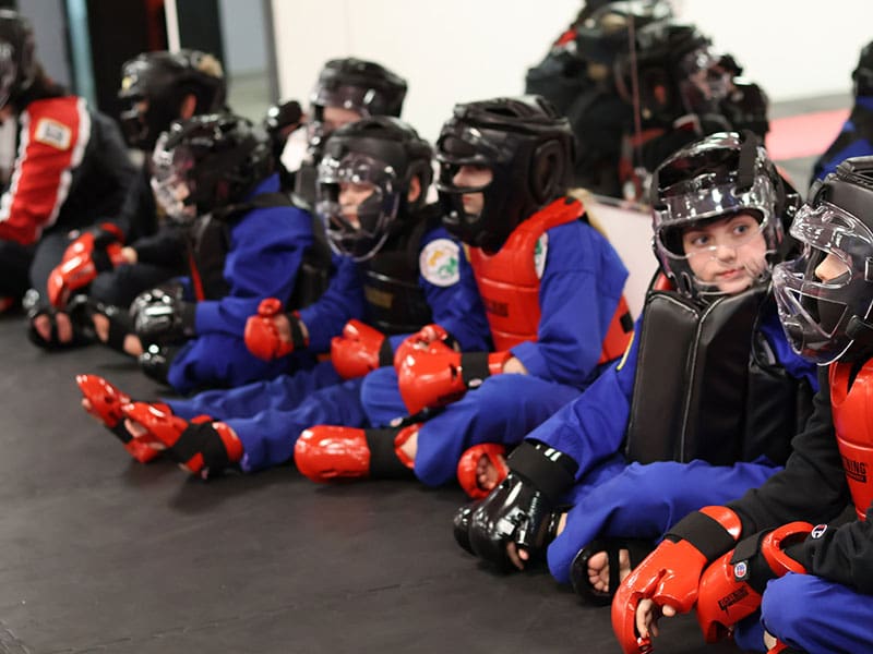Happy kids in Hudson learning martial arts, improving balance, coordination, and having fun while building life skills.